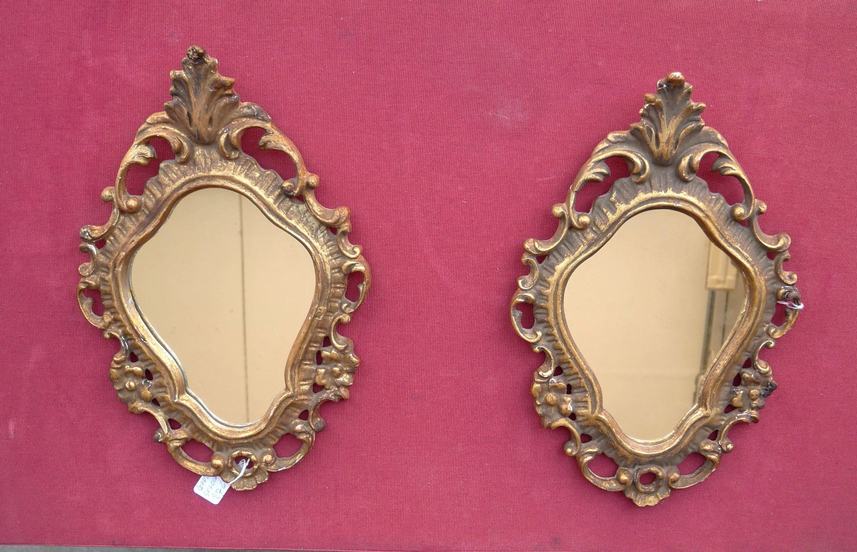 Pair of small antique carved frame mirrors.